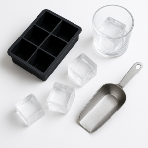 Silicone square ice tray with large clear ice cubes displayed on a kitchen countertop